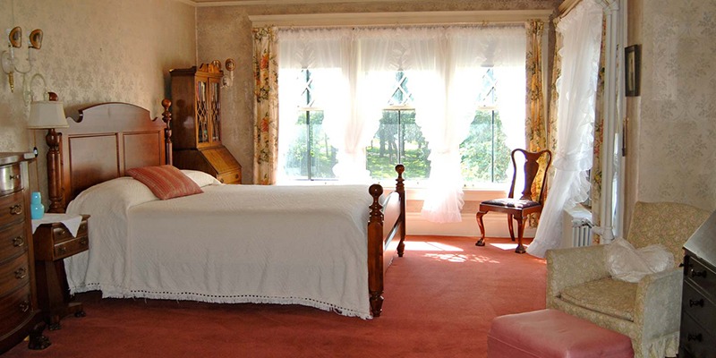 Furnished bedroom for lodging accomodations at the Musser mansion in Little Falls, MN
